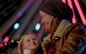 Father and daugher enjoing hot chocolate and a happy winter evening at the Branson Ferris Wheel.